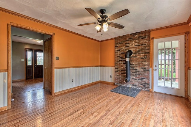 5569 Camerons Rd, Brush Val/Buffington, PA 15748 - spare room with a wood stove, wood finished floors, ceiling fan, and baseboards
