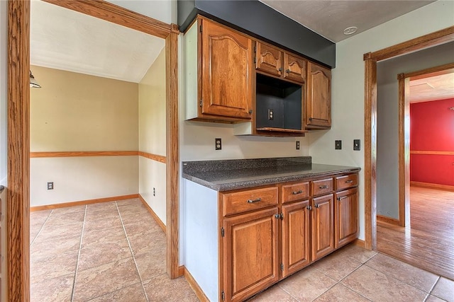 5569 Camerons Rd, Brush Val/Buffington, PA 15748 - kitchen featuring dark countertops, brown cabinets, baseboards, and light tile patterned flooring