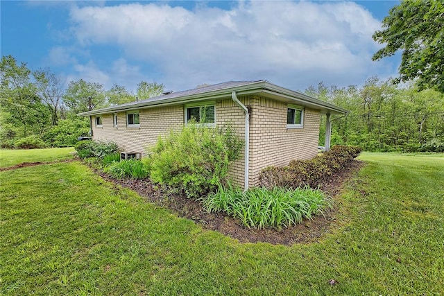 view of side of property with a yard