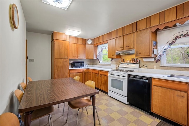 3072 Millerstown Rd, Clarion, PA 16254 - kitchen with black dishwasher, white gas range, built in microwave, under cabinet range hood, and light flooring