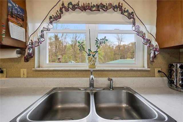 3072 Millerstown Rd, Clarion, PA 16254 - kitchen view of a sink, decorative backsplash, and light stone counters