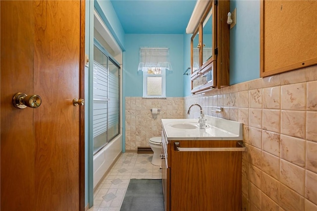 3072 Millerstown Rd, Clarion, PA 16254 - full bathroom featuring toilet, tile walls, vanity, wainscoting, and tile patterned floors