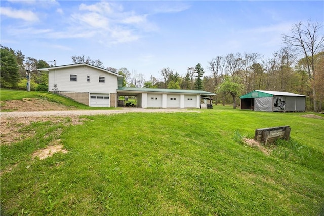 3072 Millerstown Rd, Clarion, PA 16254 - rear view of house with driveway, a lawn, and a garage