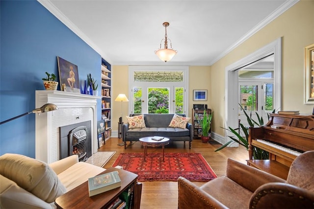 living room with crown molding, plenty of natural light, wood finished floors, baseboards, and a fireplace with flush hearth