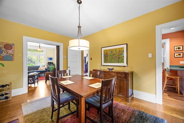dining area featuring wood finished floors and baseboards