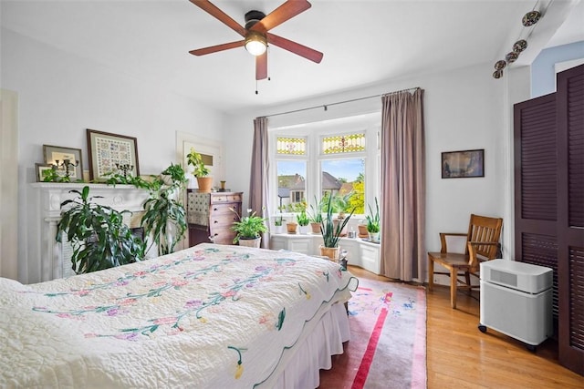 bedroom featuring light wood-type flooring and ceiling fan