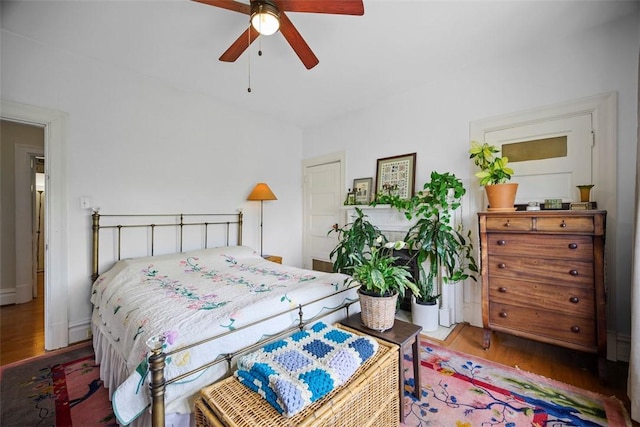 bedroom featuring wood finished floors and a ceiling fan