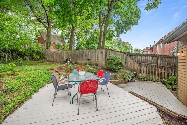 deck featuring a fenced backyard and outdoor dining space