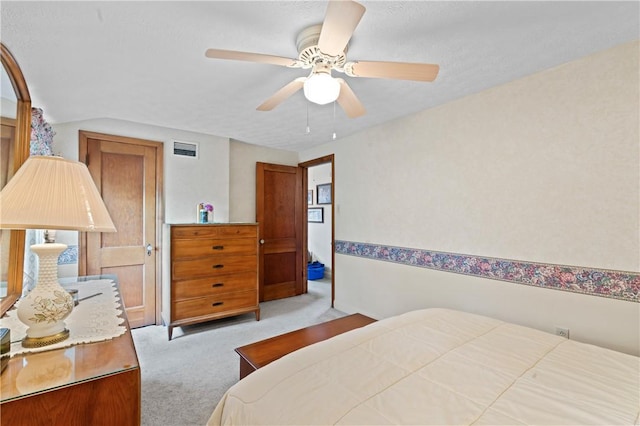 bedroom with light colored carpet and a ceiling fan