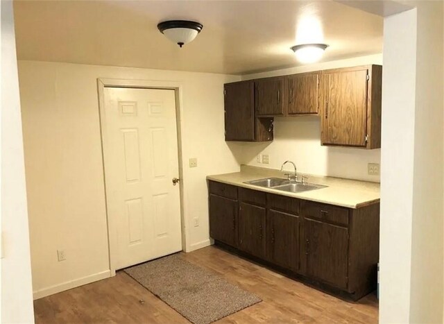 449 N Water Ave, Sharon, PA 16146 - kitchen with a sink, light countertops, light wood-style floors, dark brown cabinets, and baseboards