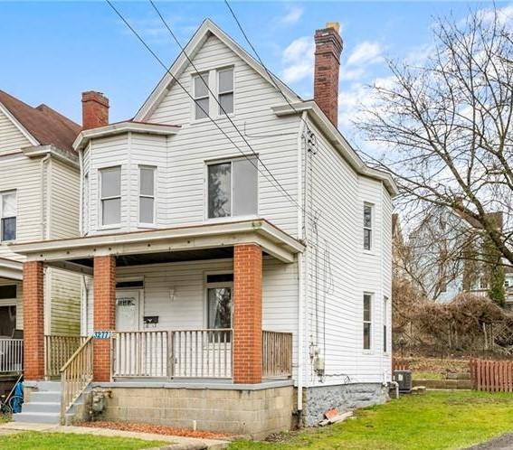 3277 Tuxedo St, Sheraden, PA 15204 - view of front of home with covered porch, a chimney, and a front lawn