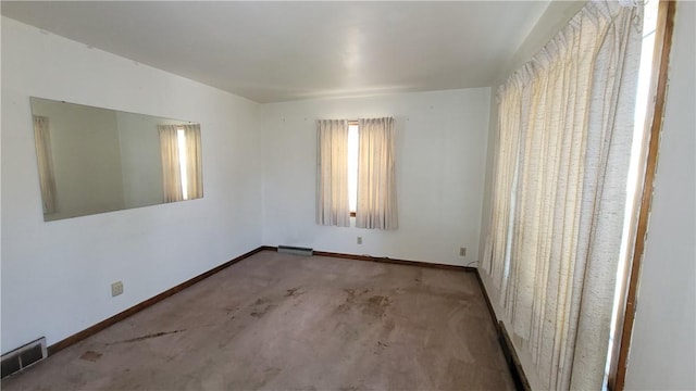 carpeted empty room with baseboards
