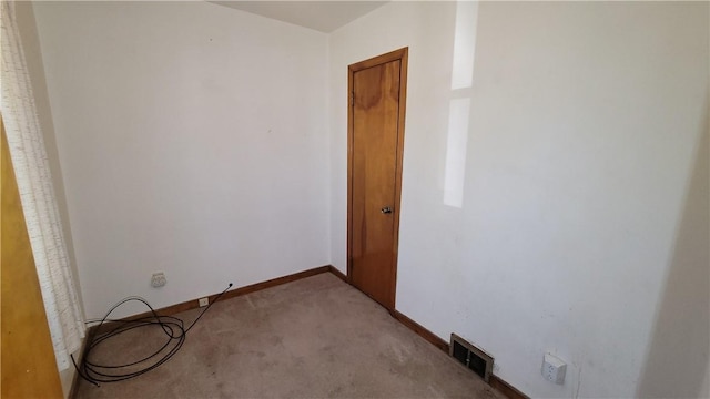unfurnished room featuring carpet floors and baseboards