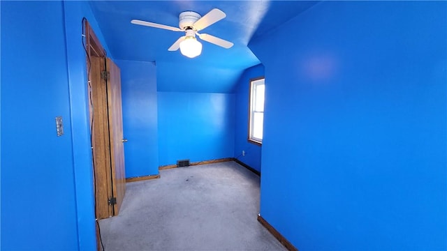 unfurnished room featuring baseboards, carpet flooring, lofted ceiling, and ceiling fan