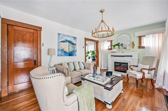 188 Taylor Ave, Sharon, PA 16146 - living room with light wood-style flooring, a glass covered fireplace, and a chandelier