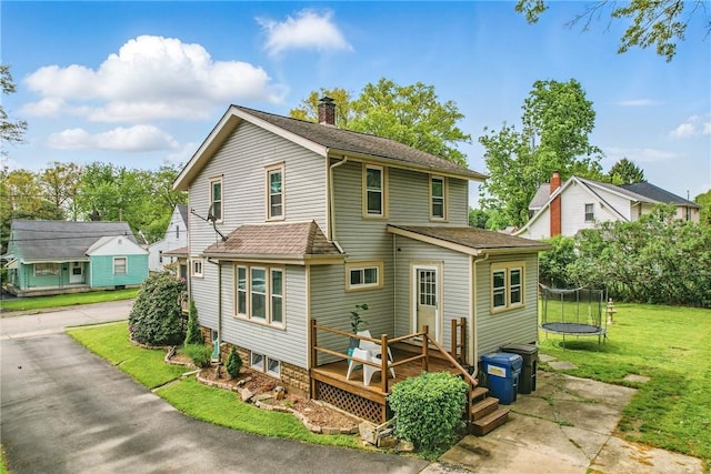 188 Taylor Ave, Sharon, PA 16146 - view of front of house with a trampoline, a chimney, a wooden deck, and a front lawn
