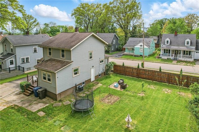 188 Taylor Ave, Sharon, PA 16146 - rear view of house with a trampoline, a residential view, roof with shingles, a fire pit, and central AC unit