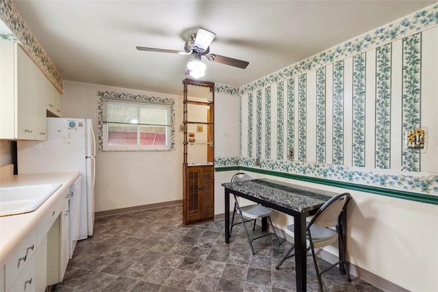 1023 Harrison St, Bethel Park, PA 15234 - kitchen with white cabinets, a ceiling fan, a sink, and baseboards