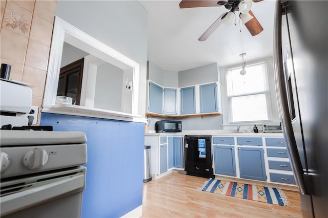 351 Center Ave, West View, PA 15229 - kitchen with black appliances, blue cabinetry, a ceiling fan, light countertops, and light wood finished floors