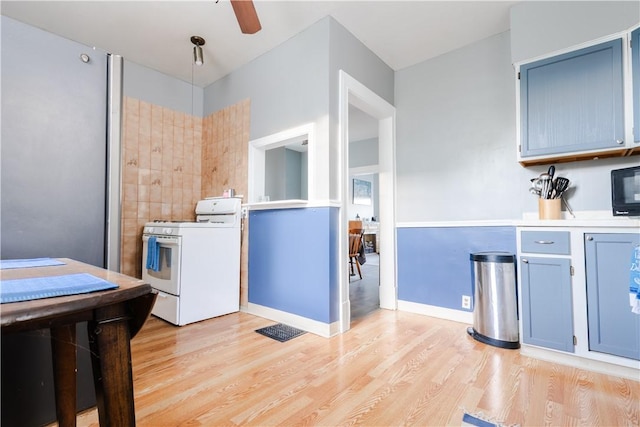 351 Center Ave, West View, PA 15229 - kitchen with gas range gas stove, light wood-style flooring, a ceiling fan, light countertops, and black microwave
