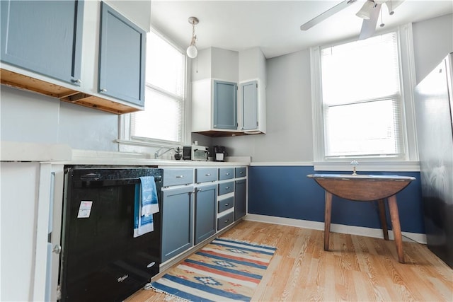 351 Center Ave, West View, PA 15229 - kitchen featuring blue cabinets, light wood finished floors, freestanding refrigerator, and light countertops