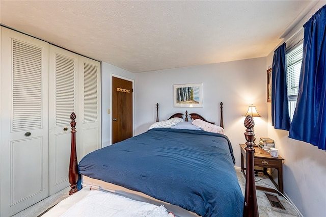 carpeted bedroom with a closet and baseboards
