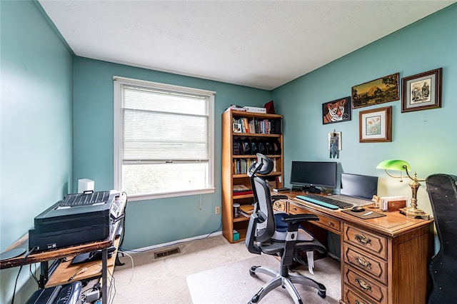 carpeted office space featuring baseboards