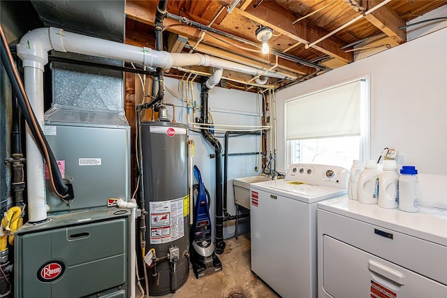 laundry room featuring washing machine and clothes dryer, water heater, and heating unit