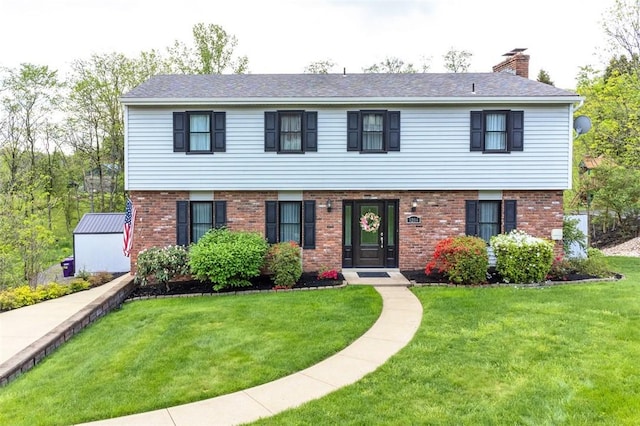 9204 Douglas Fir Dr, Plum Boro, PA 15239 - colonial-style house with brick siding, a front yard, and a chimney