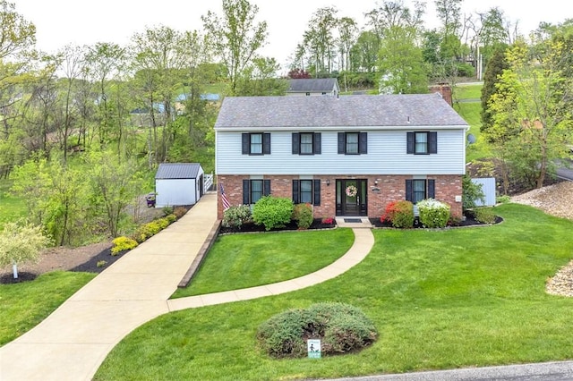 9204 Douglas Fir Dr, Plum Boro, PA 15239 - view of front of home with brick siding, a front lawn, and an outdoor structure