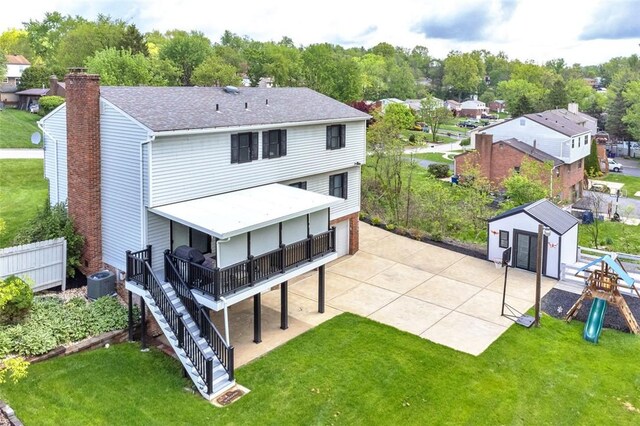 9204 Douglas Fir Dr, Plum Boro, PA 15239 - back of house featuring a lawn, a wooden deck, a playground, and roof with shingles