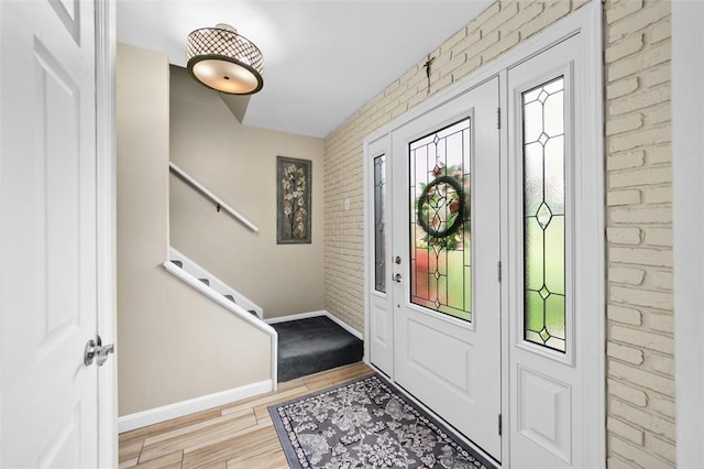 9204 Douglas Fir Dr, Plum Boro, PA 15239 - entrance foyer featuring brick wall, wood finished floors, baseboards, and stairs