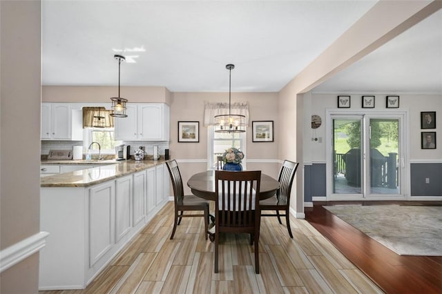 9204 Douglas Fir Dr, Plum Boro, PA 15239 - dining space with plenty of natural light, light wood-style flooring, a chandelier, and baseboards