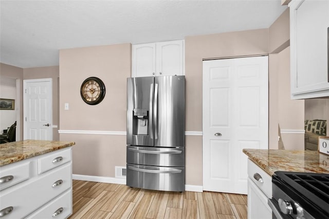 9204 Douglas Fir Dr, Plum Boro, PA 15239 - kitchen with stainless steel fridge, white cabinetry, light stone counters, light wood-style floors, and baseboards