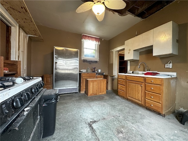 218 Keystone Way, Ellwood City Law, PA 16117 - kitchen featuring brown cabinets, a sink, freestanding refrigerator, range with gas stovetop, and light countertops
