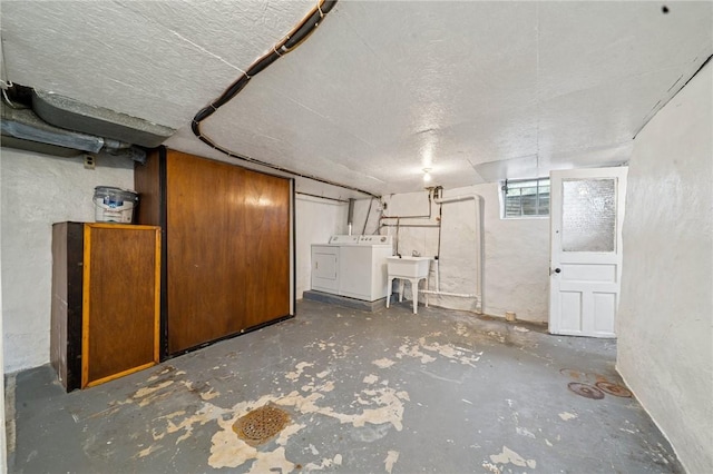 basement with washer and dryer and a sink