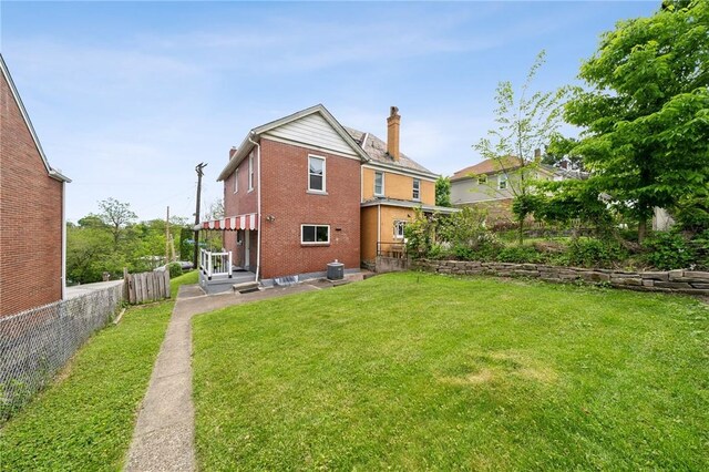 rear view of property with brick siding and a chimney
