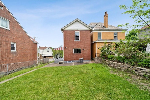 back of house featuring a chimney, a patio, and brick siding