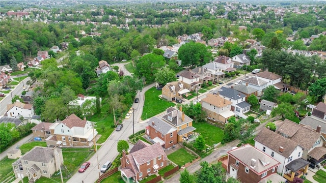 aerial view of property and surrounding area with nearby suburban area
