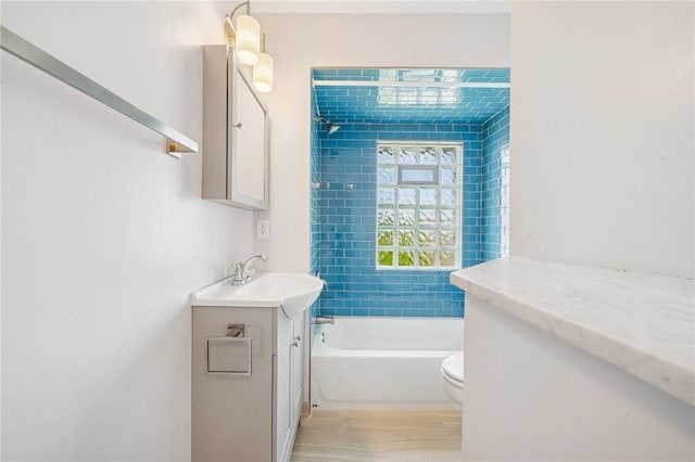 bathroom featuring vanity, toilet, and shower / bath combination
