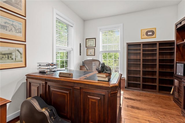 office area with plenty of natural light and light wood-style floors