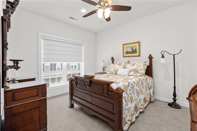 bedroom with light colored carpet, baseboards, and ceiling fan