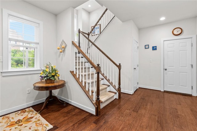 entryway with wood finished floors, stairway, baseboards, and recessed lighting