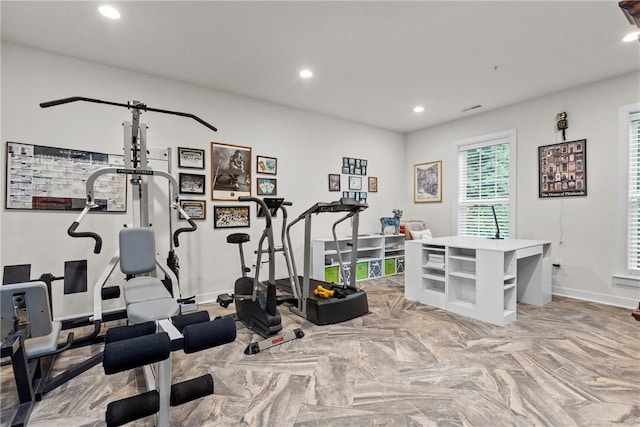 exercise room with recessed lighting and baseboards