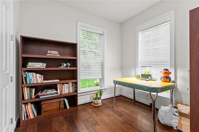 office space with plenty of natural light, wood finished floors, and baseboards