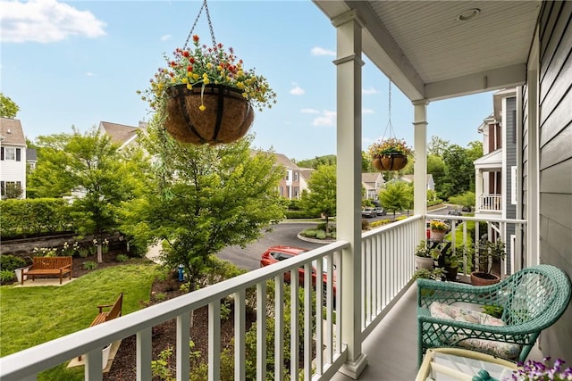 balcony with covered porch and a residential view