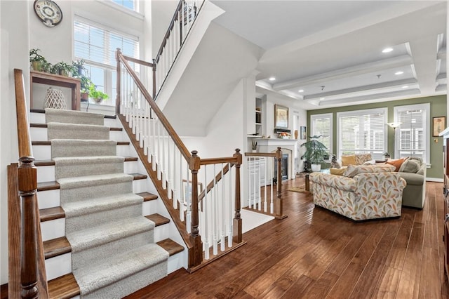 stairs featuring hardwood / wood-style flooring and recessed lighting