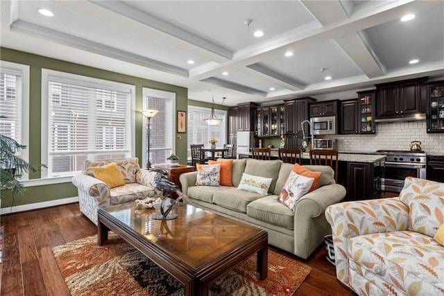 living area featuring plenty of natural light, dark wood-style floors, coffered ceiling, beam ceiling, and recessed lighting