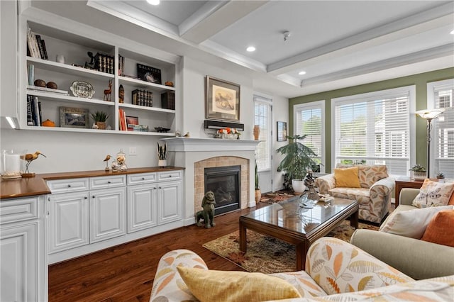 living area with beam ceiling, dark wood-type flooring, a fireplace, and recessed lighting
