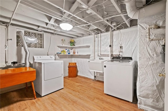 washroom featuring separate washer and dryer and light wood-type flooring